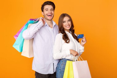 Alışveriş torbaları ve kredi kartı ile çekici çift