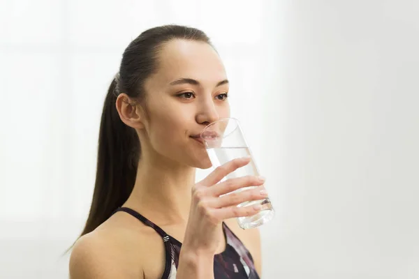 Mujer milenaria bebiendo agua dulce limpia después del entrenamiento —  Fotos de Stock
