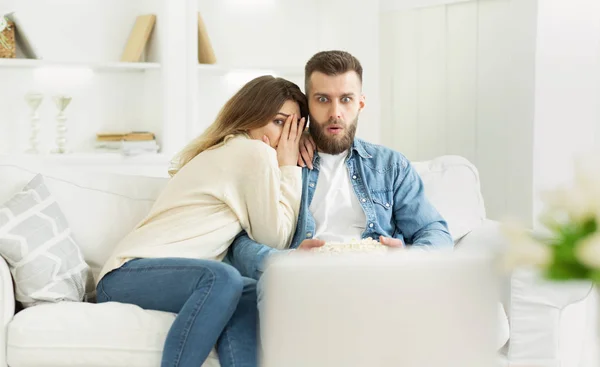 Young couple watching horror film, spending weekend at home — Stock Photo, Image
