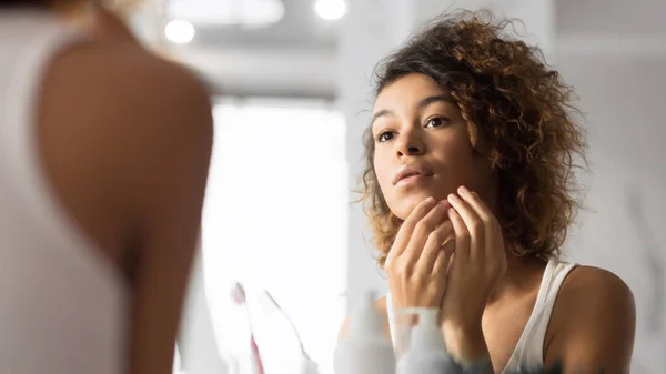 Black Millennial Girl Looking at Pimple In Bathroom, Panorama — стоковое фото