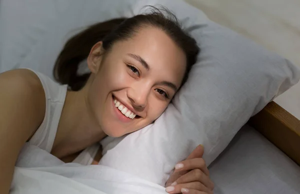 Happy woman waking up with sunbeam on her face — Stock Photo, Image