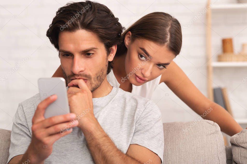 Jealous Wife Spying On Husband While He Texting On Phone Indoor