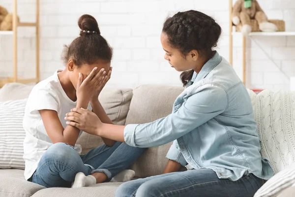 Young crying girl being consoled by her elder sister — Stock Photo, Image