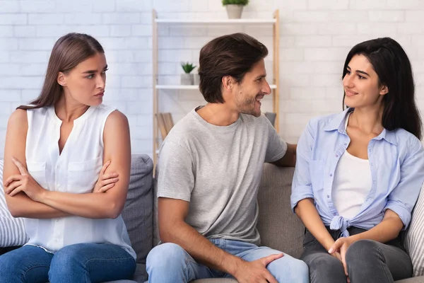 Envious Girl Looking At Flirting Couple Sitting On Sofa Indoor — Stock Photo, Image