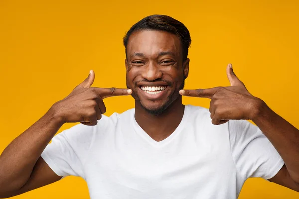 Black Man Pointing Fingers At His White Toothy Smile, Studio — Stock Photo, Image