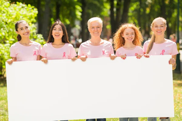 Les bénévoles de cancer du sein tenant le tableau blanc vide pour le texte extérieur — Photo