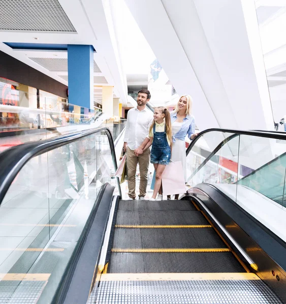 Parents And Daughter Going Up On Escalator In Shopping Center — Stock Photo, Image