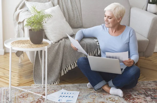 Senior financial consultant working with laptop at home