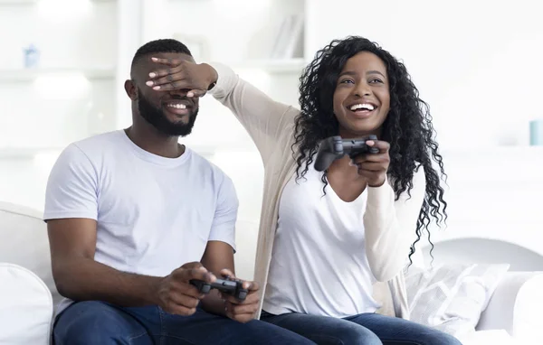 Millennial pareja jugando videojuegos sentado en el sofá en casa . — Foto de Stock