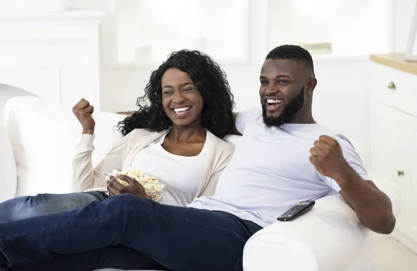 Married couple watching sport on tv, supporting their favorite team — Stockfoto