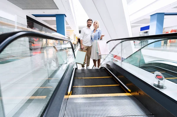Couple Walking Up Escalator Shopping In Hypermarket — Stock Photo, Image