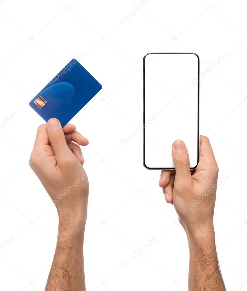Credit card and smartphone with blank screen in male hands