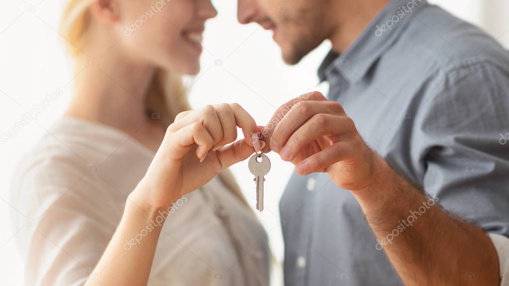 Unrecognizable Man And Woman Hugging Holding New Home Key Indoor