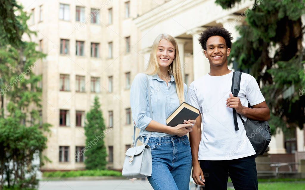 College students. Teens posing to camera in campus