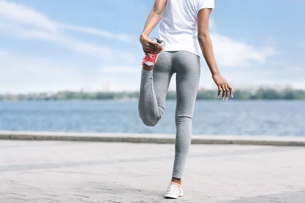 Unrecognizable Black Girl Warming Up Before Morning Run Outdoor