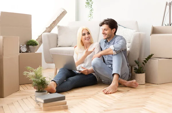 Young Couple Relaxing Sitting With Laptop On Floor Indoor