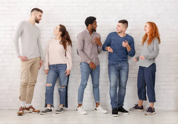 Young stylish friends talking, having break at college — Stock Photo, Image