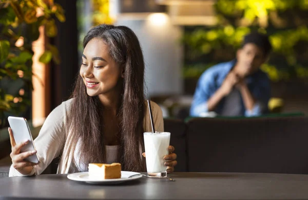 Mladá hezká dívka pomocí aplikace pro randění v kavárně — Stock fotografie