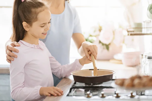 Cute little girl cooking together with mom — Stock Photo, Image