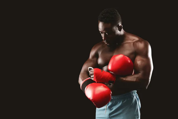 Boxeador muscular negro usando guantes rojos antes de la pelea —  Fotos de Stock