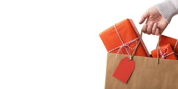 Woman holding paper bag with Christmas gifts for family — Stock Photo, Image