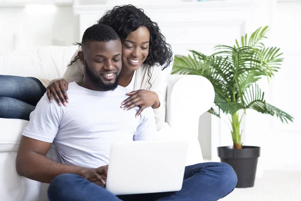 Happy young african american couple using portable pc at home — Stok Foto