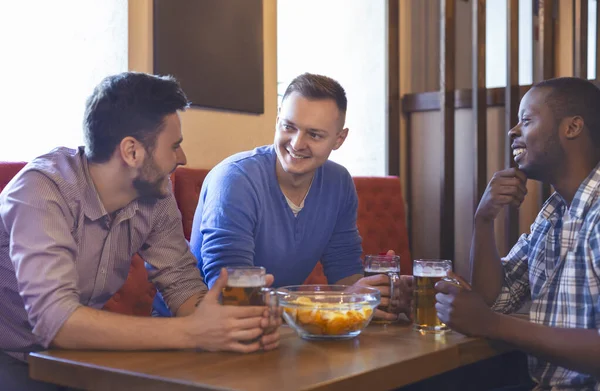 Tres chicos jóvenes pasando un buen rato en el bar — Foto de Stock