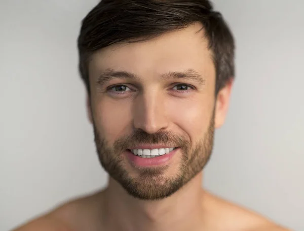Volwassen man glimlachen op camera poseren over witte achtergrond — Stockfoto