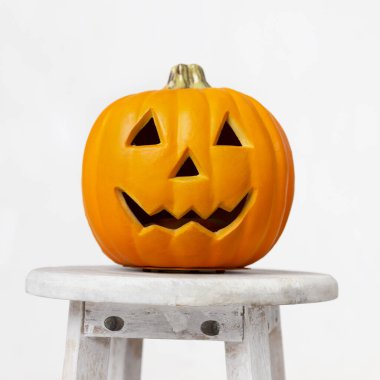 Cadılar Bayramı balkabağı süslemesi ve sandalyede yüz kesme