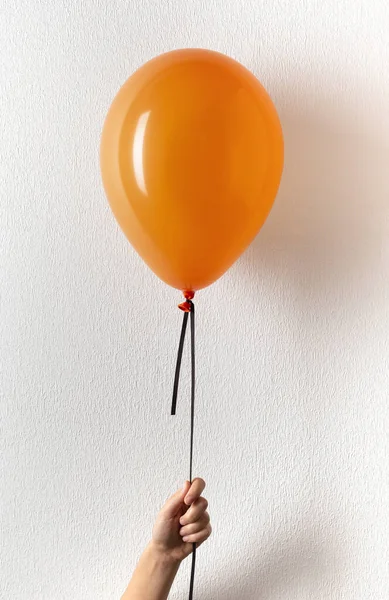 Woman holding orange balloon with copy space — Stock Photo, Image