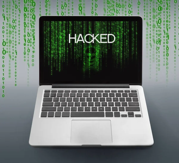 Laptop with hacked message and binary code numbers on screen — Stock Photo, Image