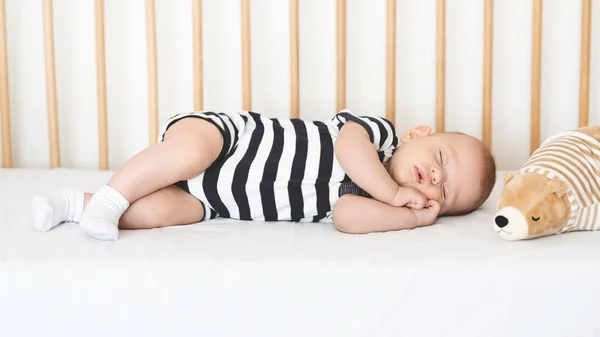 Adorable bebé recién nacido durmiendo de costado en la cuna —  Fotos de Stock