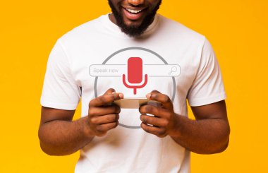 Afrikalı adam akıllı telefondan ses araması yapıyor, sarı arkaplan