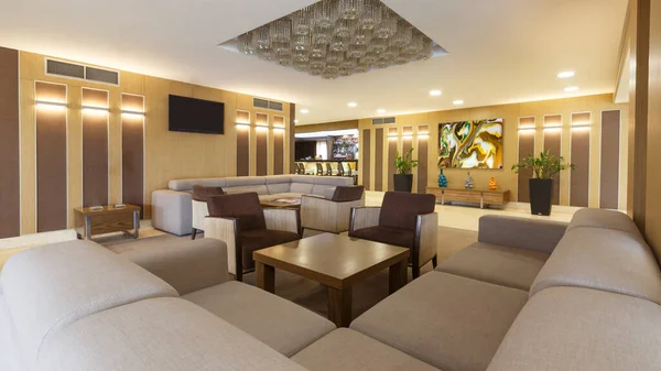 Большой диван, стол и растения в гостиной отеля — стоковое фото