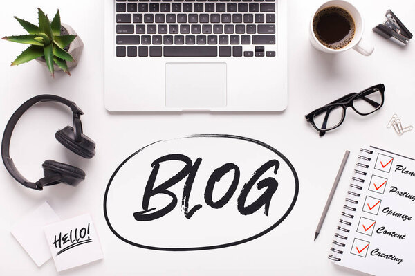 Overhead view of bloggers workplace with laptop computer and headphones, collage