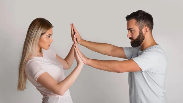 Affronter le répresseur domestique. L'homme presse la femme avec ses mains, la fille résiste — Photo