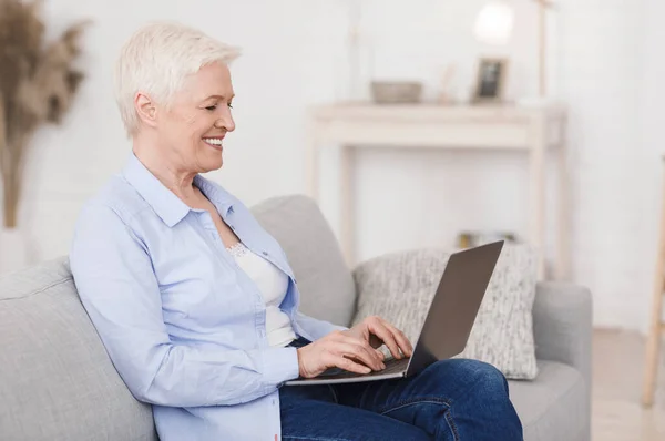 Dating Sites For Seniors. Portrait of elderly lady with laptop at home