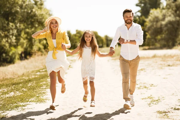 Cheerful Parents And Daughter Walking Holding Hands Outdoors — Stock Photo, Image