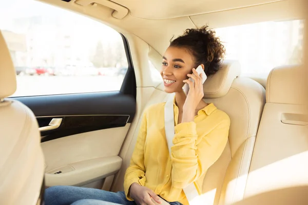 택시 를 타고 앉아서 통화하는 점잖은 흑인 여자 — 스톡 사진