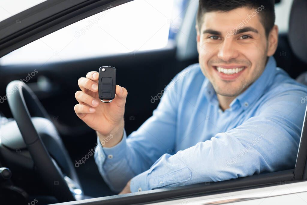 Joyful Man Showing Key Sitting In Drivers Seat