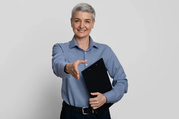 Recruitment concept. Friendly middle-aged HR manager extending hand for handshake at camera — Stock Photo, Image