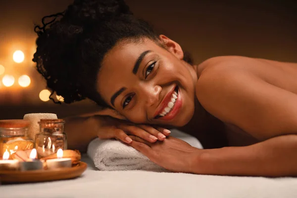 Close up of joyful black lady laying at spa salon — Stock Photo, Image