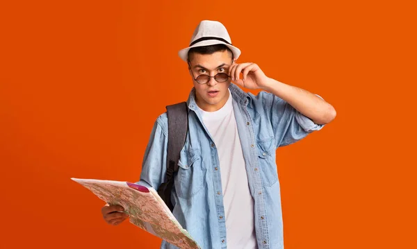 Viajero sorprendido con gafas de mano en el mapa de la ciudad — Foto de Stock