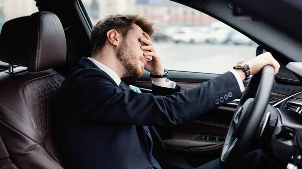 Smutny młody biznesmen jadący sam w swoim nowym samochodzie — Zdjęcie stockowe