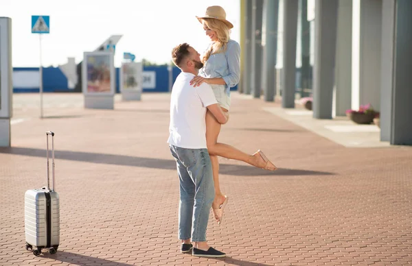 Hombre recogiendo a su novia cerca del edificio del aeropuerto — Foto de Stock