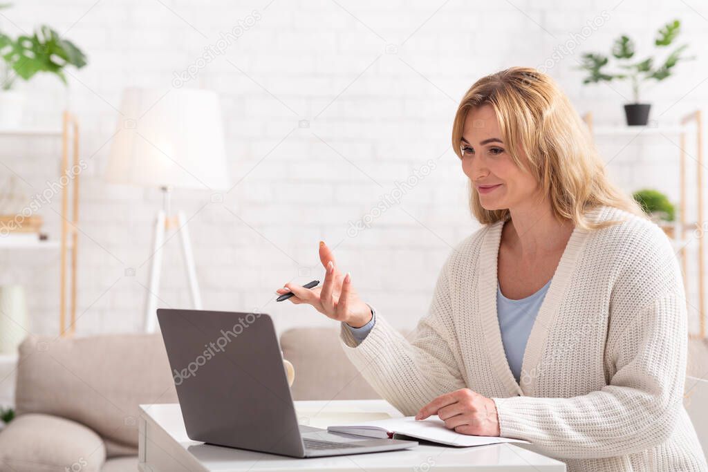 School, college and university online. Smiling female teacher holds lessons on laptop