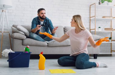 Quarrel over indifference in family. Wife swears with husband, playing computer games clipart