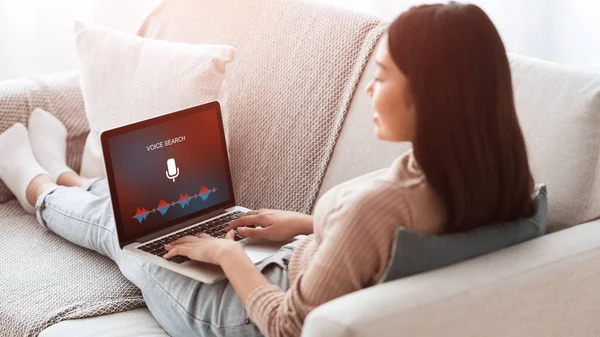 Asian Girl Using Voice Search On Laptop Sitting At Home