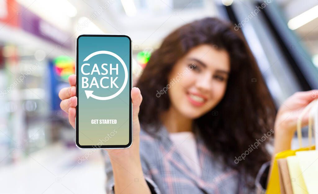 Young Woman Holding Smartphone With Opened Cashback Application On Screen
