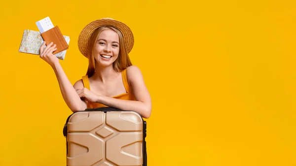 Dívka turistický opřít o kufr, držení vstupenky a mapu, připraven k cestování — Stock fotografie